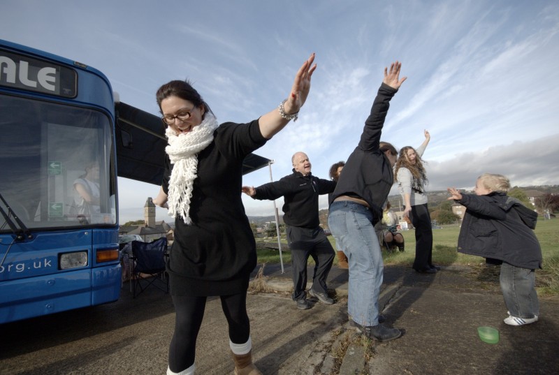 HALE health action local engagement PR photography Charity workers dancing in front of a bus