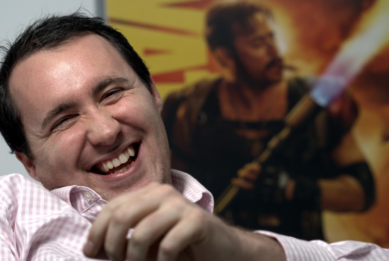 NHS Views magazine editorial photography Man smiling in front of a movie poster