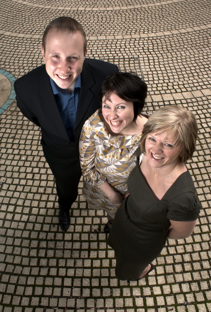 NHS Views editorial photograph Three people looking up towards the camera and smiling