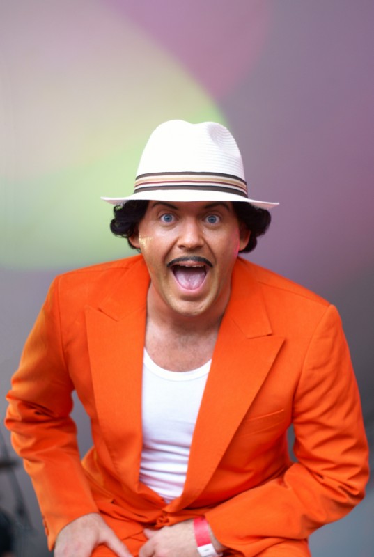 Cuban Brothers at Beach Break Live Man smiling with a hat on and orange jacket