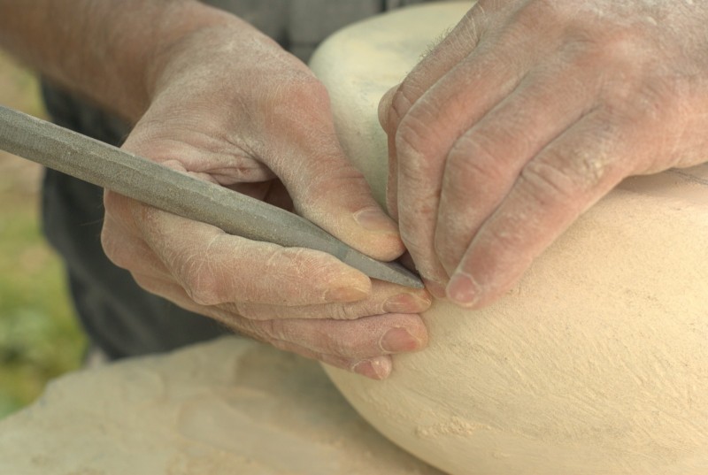 Stone carving art event at Yorkshire Sculpture Park Hands carving stone at an event at Yorkshire Sculpture Park