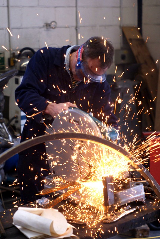 Hot and cold metal art event at Yorkshire Sculpture Park Sparks coming from a man grinding metal