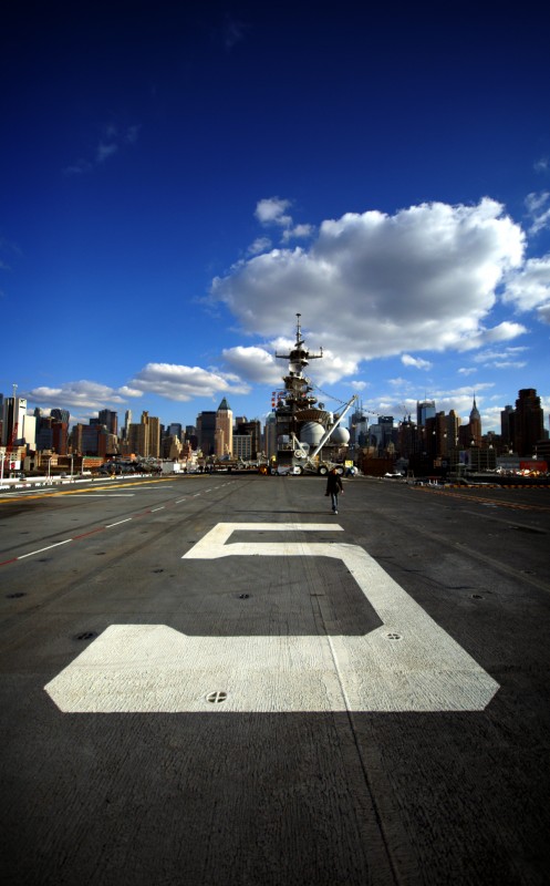Aircraft carrier in Manhattan The number '5' painted on the deck of an aircraft carrier moored in front of Manhattan island