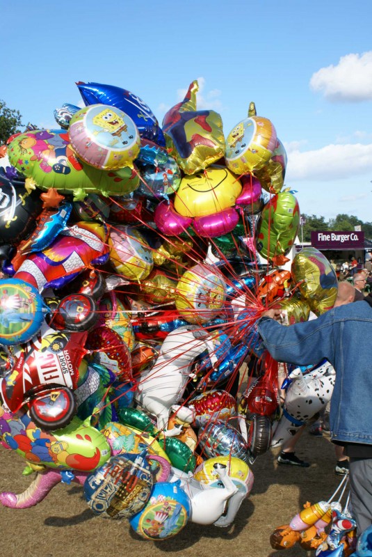 Balloons at Latitude festival A group of colourful helium balloons held by a vendor