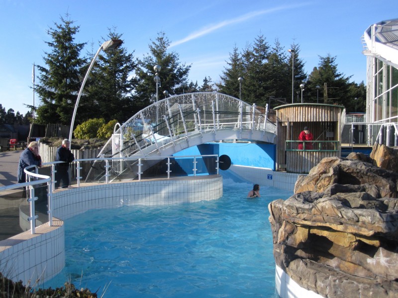 Center Parcs A lifeguard and two spectators look at a girl in a swimming pool