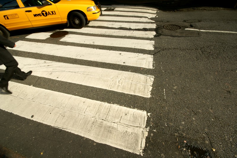 New York street A taxi driving over a pedestrian crossing in New York