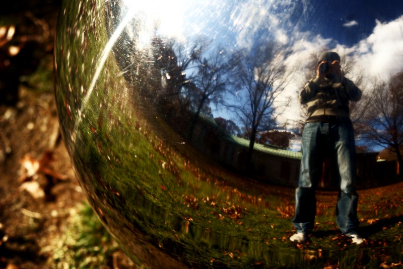 Silver orb Reflection of a photographer in a silver orb in a park in New York