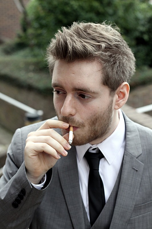 Smoker Man in a suit smoking a cigarette at a hotel in Lawnswood in Leeds